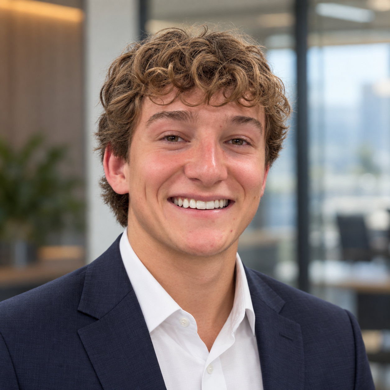 Miles Wrubel smiling in a navy suit